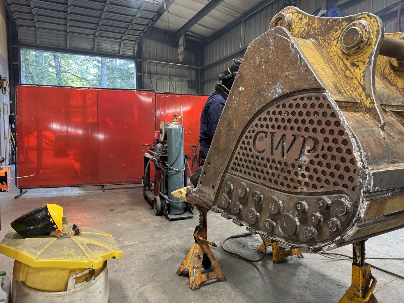 CWP excavator bucket fitted with a custom wear package in the shop