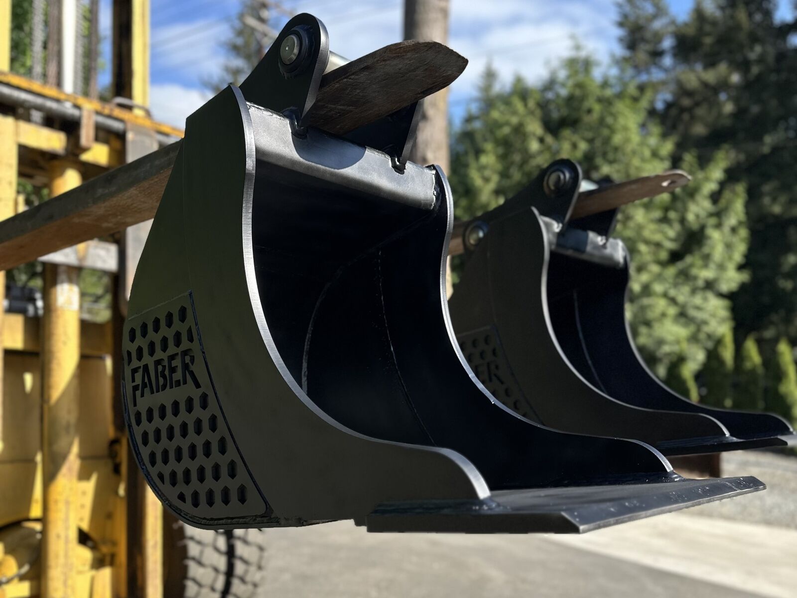 Matched set of new long-lip trenching buckets ready for delivery