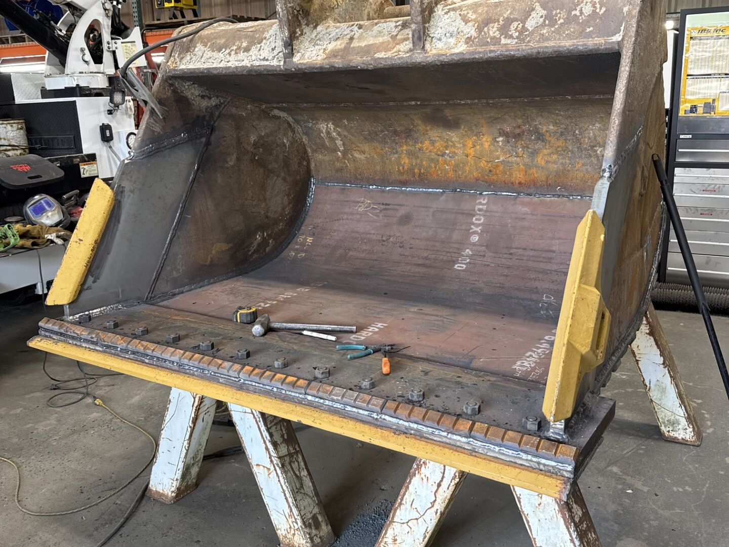 Wear steel liner plates welded into an excavator bucket